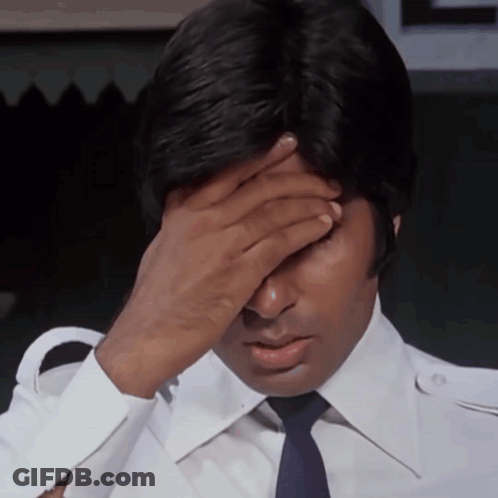 A Man In A White Shirt And Blue Tie Covers His Face With His Hand GIF