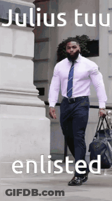 A Man In A White Shirt And Blue Tie Is Walking Down A Sidewalk Carrying A Duffel Bag .. GIF