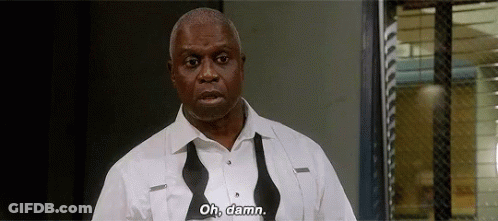 A Man In A White Shirt And Bow Tie Is Standing In Front Of A Window And Says `` Oh , Damn '' . GIF