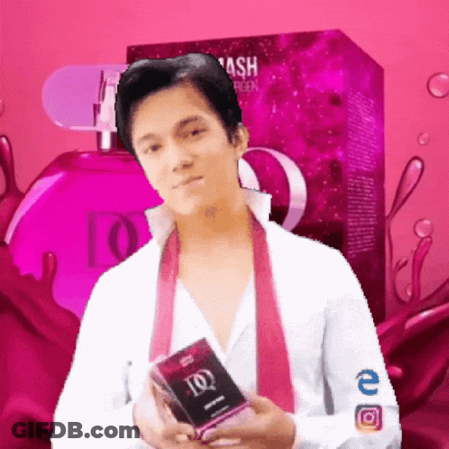A Man In A White Shirt And Pink Tie Is Holding A Box Of Ash Perfume GIF