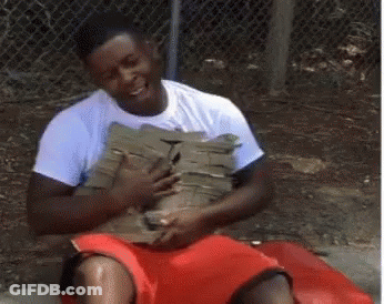 A Man In A White Shirt And Red Shorts Is Sitting On A Bench Holding A Bag . GIF