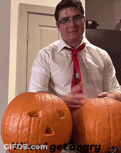 A Man In A White Shirt And Red Tie Is Holding Two Pumpkins With The Words When I Get Angry Written On Them GIF