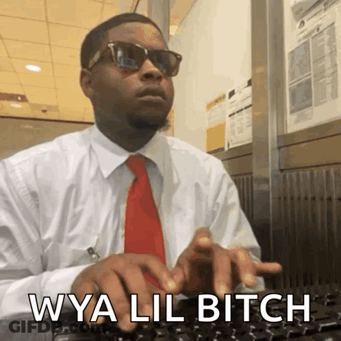 A Man In A White Shirt And Red Tie Is Typing On A Keyboard With The Words Wya Lil Bitch Written Below Him GIF
