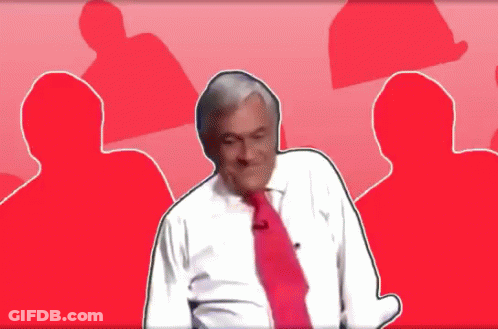 A Man In A White Shirt And Red Tie Stands In Front Of A Red Background GIF