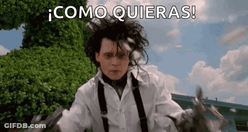 A Man In A White Shirt And Suspenders Is Holding A Pair Of Scissors In His Hand . GIF