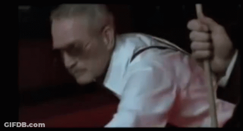 A Man In A White Shirt And Suspenders Is Holding A Rope . GIF