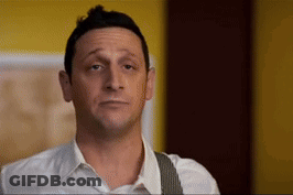 A Man In A White Shirt And Suspenders Is Making A Face GIF