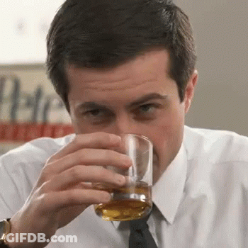 A Man In A White Shirt And Tie Drinks A Glass Of Whiskey GIF