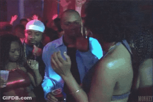 A Man In A White Shirt And Tie Is Dancing In A Club Holding A Cup Of Beer . GIF