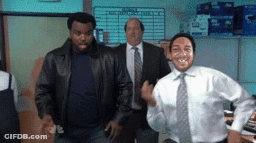 A Man In A White Shirt And Tie Is Dancing In An Office While Two Men In Suits Are Standing Behind Him . GIF