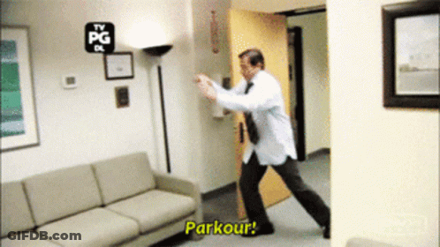 A Man In A White Shirt And Tie Is Doing A Parkour GIF