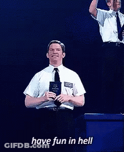 A Man In A White Shirt And Tie Is Holding A Book And Smiling With The Words Have Fun In Hell Below Him GIF