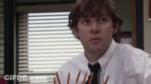A Man In A White Shirt And Tie Is Holding A Bunch Of Pencils In His Hands . GIF
