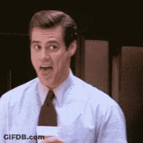 A Man In A White Shirt And Tie Is Holding A Cup And Making A Surprised Face GIF