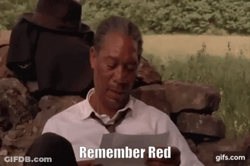 A Man In A White Shirt And Tie Is Holding A Piece Of Paper That Says " Remember Red " GIF