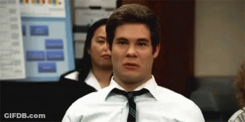 A Man In A White Shirt And Tie Is Making A Face . GIF