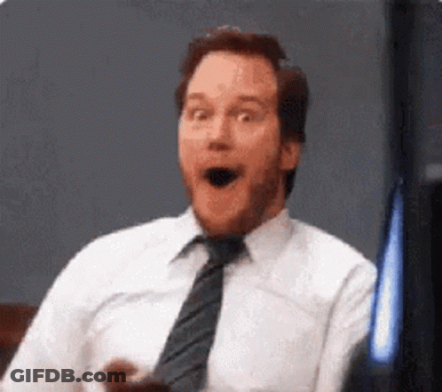 A Man In A White Shirt And Tie Is Making A Funny Face . GIF