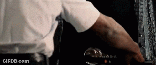 A Man In A White Shirt And Tie Is Pressing A Button On A Computer Keyboard . GIF