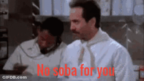 A Man In A White Shirt And Tie Is Sitting At A Desk And Says No Soba For You GIF