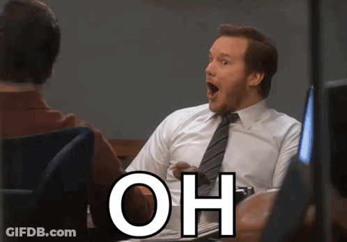 A Man In A White Shirt And Tie Is Sitting At A Desk With His Mouth Open And The Word Oh Written Below Him GIF