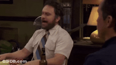 A Man In A White Shirt And Tie Is Sitting At A Table GIF