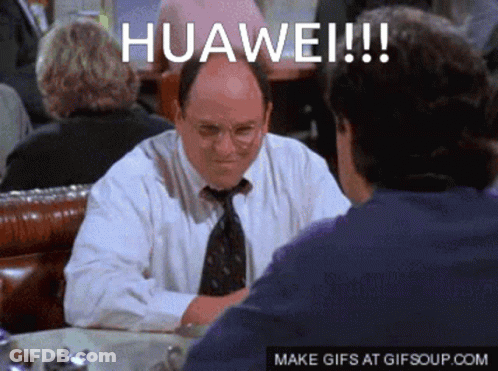 A Man In A White Shirt And Tie Is Sitting At A Table Talking To Another Man With The Words Huawei Written On The Screen GIF