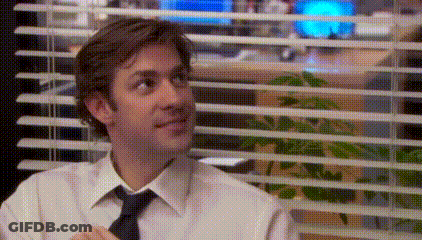 A Man In A White Shirt And Tie Is Sitting In Front Of A Window In An Office . GIF