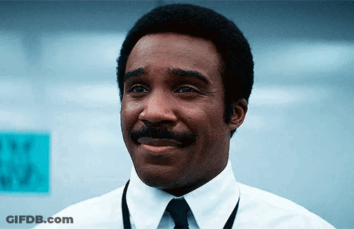 A Man In A White Shirt And Tie Is Smiling . GIF