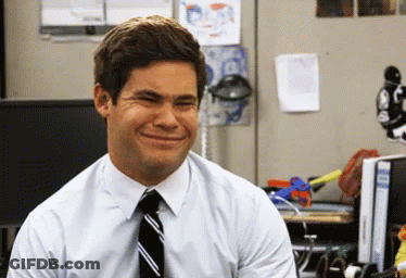 A Man In A White Shirt And Tie Is Smiling In An Office GIF