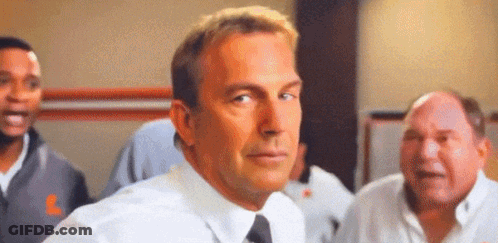 A Man In A White Shirt And Tie Is Standing In Front Of A Group Of People . GIF