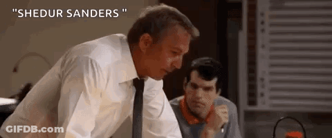 A Man In A White Shirt And Tie Is Standing Next To Another Man In A Room . GIF