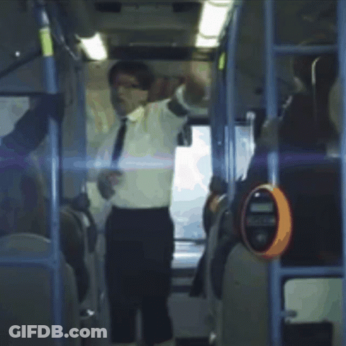 A Man In A White Shirt And Tie Is Standing On A Bus With His Arms Outstretched GIF