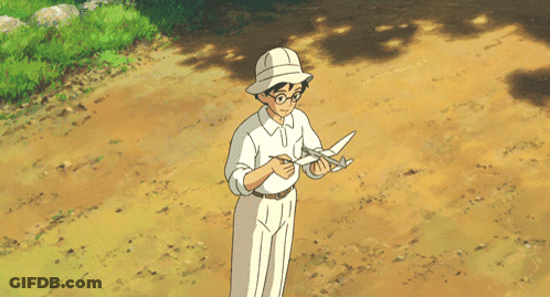 A Man In A White Shirt And White Pants Is Standing On A Dirt Road GIF