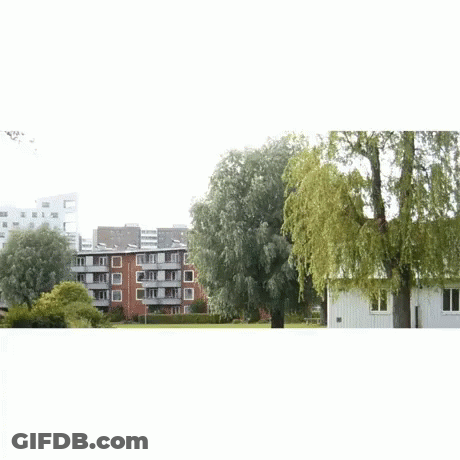 A Man In A White Shirt And Yellow Pants Is Dancing GIF