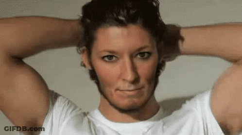 A Man In A White Shirt Has His Hands On His Head GIF