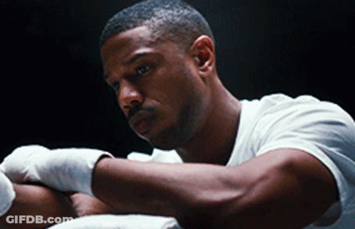 A Man In A White Shirt Has His Hands Wrapped In Bandages GIF