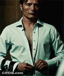 A Man In A White Shirt Has His Shirt Open GIF