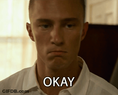 A Man In A White Shirt Has The Word Okay Written On His Neck GIF