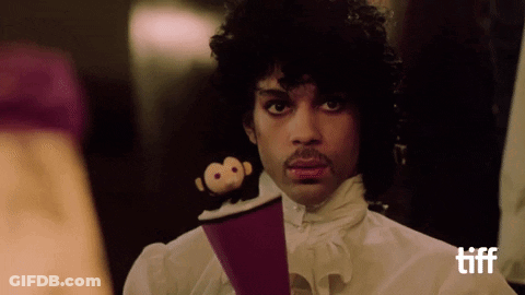 A Man In A White Shirt Holds A Stuffed Monkey On A Purple Object GIF