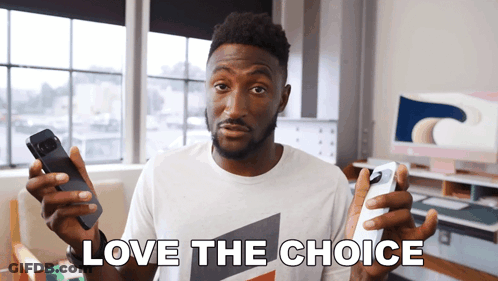 A Man In A White Shirt Holds Two Phones In His Hands And Says Love The Choice GIF