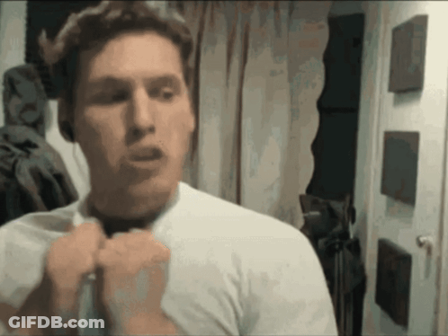 A Man In A White Shirt Is Adjusting His Bow Tie GIF