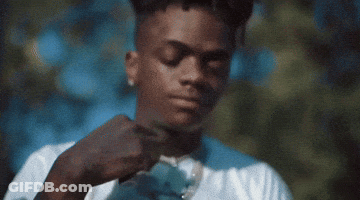 A Man In A White Shirt Is Adjusting His Tie . GIF