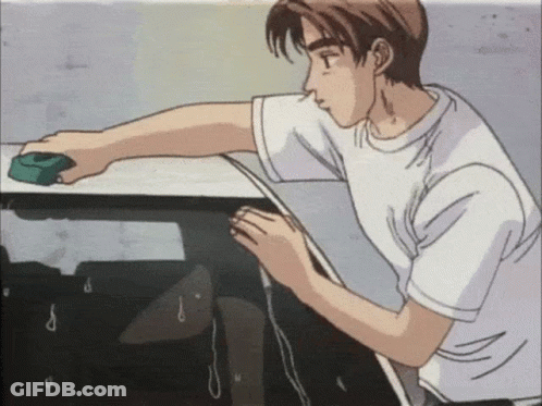 A Man In A White Shirt Is Cleaning A Table GIF