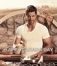 A Man In A White Shirt Is Cooking In A Frying Pan . GIF