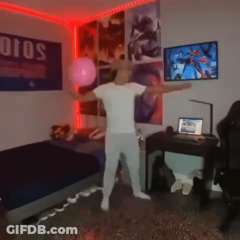 A Man In A White Shirt Is Dancing In A Bedroom With Posters On The Wall . GIF