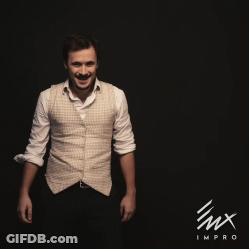A Man In A White Shirt Is Dancing In Front Of A Black Background With The Word Impro On It GIF