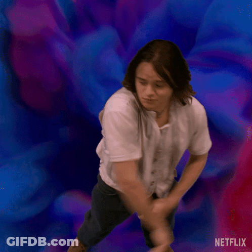 A Man In A White Shirt Is Dancing In Front Of A Blue And Purple Background . GIF