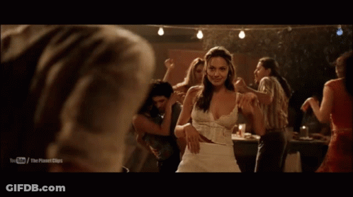 A Man In A White Shirt Is Dancing With A Woman In A Dark Room With A Youtube Logo On The Bottom GIF