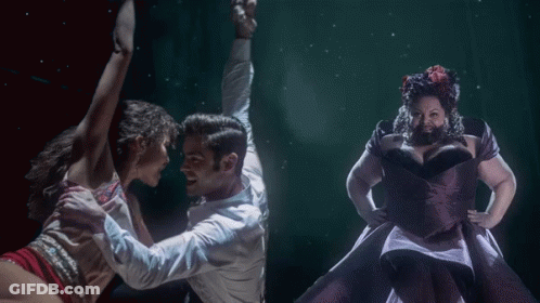 A Man In A White Shirt Is Dancing With Two Women GIF
