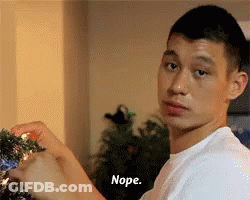 A Man In A White Shirt Is Decorating A Christmas Tree And Says Nope In Front Of Him GIF